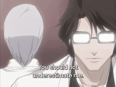 A Man With Glasses Says " You Should Not Underestimate Me " In Front Of A Woman GIF