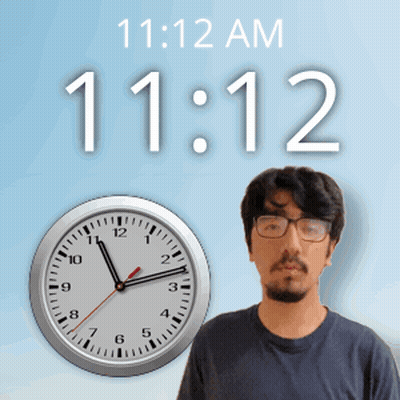 A Man With Glasses Stands In Front Of A Clock That Reads 11:12 GIF