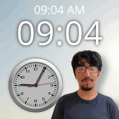 A Man With Glasses Stands In Front Of A Clock That Reads 9:04 Am GIF
