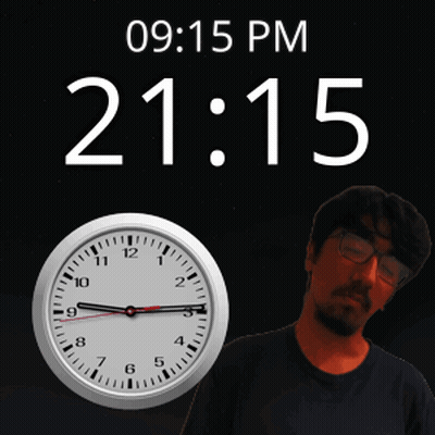 A Man With Glasses Stands In Front Of A Clock That Says 09 15 Pm GIF