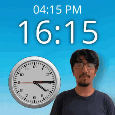 A Man With Glasses Stands In Front Of A Clock That Says 15:15 GIF