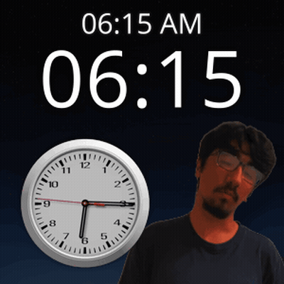 A Man With Glasses Stands In Front Of A Clock That Says 6:15 Am GIF