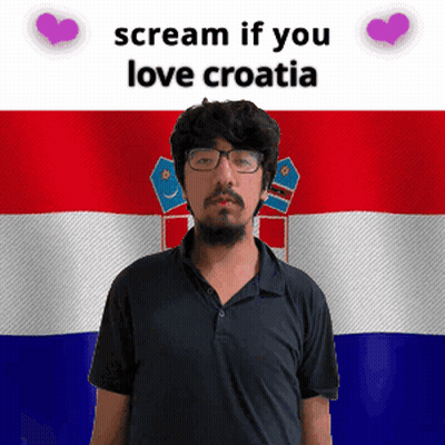 A Man With Glasses Stands In Front Of A Croatia Flag GIF