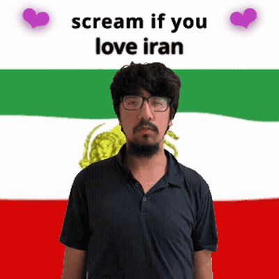 A Man With Glasses Stands In Front Of A Flag That Says Scream If You Love Iran On It GIF