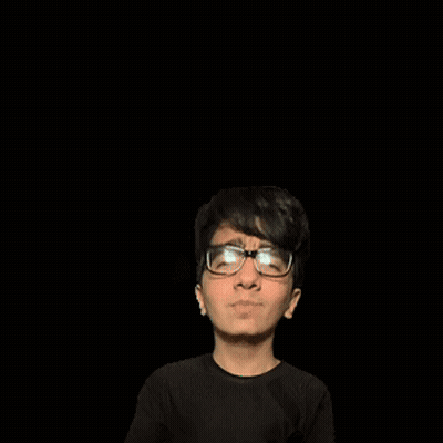 A Man With Glasses Stands In Front Of A Green A GIF