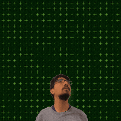 A Man With Glasses Stands In Front Of A Green Background With The Number 14 + 2 On It GIF