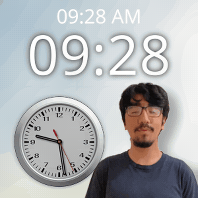 A Man With Glasses Stands In Front Of A Wall Clock That Says 09:28 Am GIF