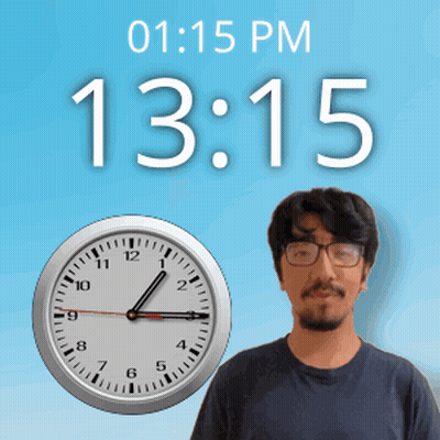 A Man With Glasses Stands In Front Of A Wall Clock That Says 13:15 GIF