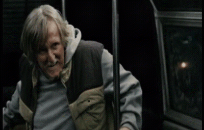 A Man With Gray Hair And A Beard Is Holding Onto A Railing With The Word Mcmuffin Written On It GIF