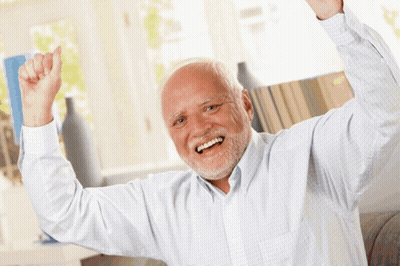 A Man With Gray Hair And A Beard Is Smiling With His Arms In The Air GIF