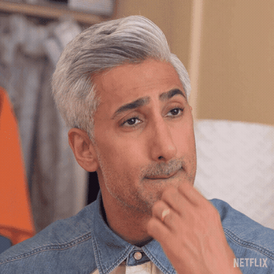 a man with gray hair and a beard is wearing a denim shirt and a netflix logo