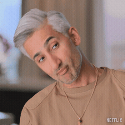 A Man With Gray Hair And A Beard Is Wearing A Tan Shirt And A Gold Necklace From Netflix GIF