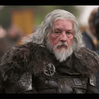 A Man With Gray Hair And A Beard Wearing A Fur Coat GIF