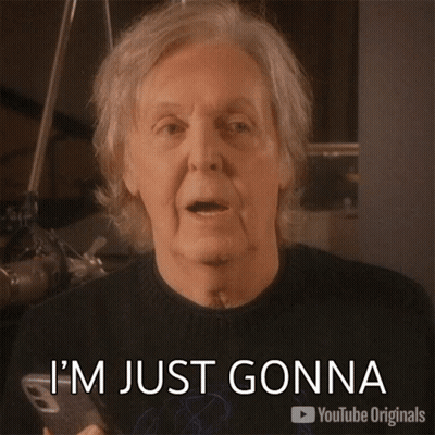 A Man With Gray Hair Is Pointing At A Cell Phone And Says Let It Be GIF
