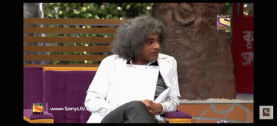 A Man With Gray Hair Is Sitting On A Couch In Front Of A Sony Tv Screen GIF