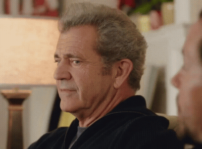 A Man With Gray Hair Is Sitting On A Couch With Another Man GIF