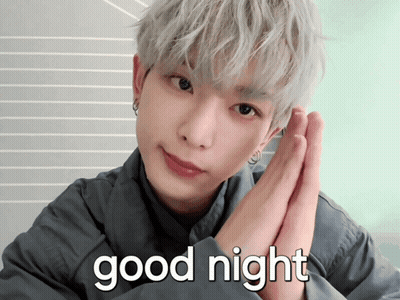 A Man With Gray Hair Says " Good Night " With His Hands Folded GIF