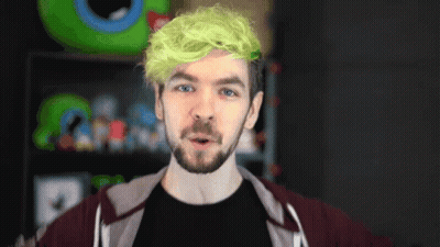 A Man With Green Hair And A Beard Is Wearing A Black Shirt GIF