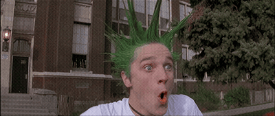 A Man With Green Hair Has A Surprised Look On His Face In Front Of A Building GIF