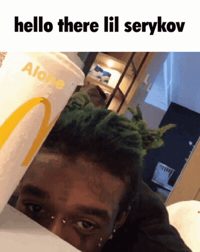 A Man With Green Hair Is Behind A Mcdonald 'S Cup That Says Alone On It GIF
