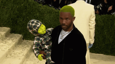 A Man With Green Hair Is Holding A Child With Shrek On It GIF