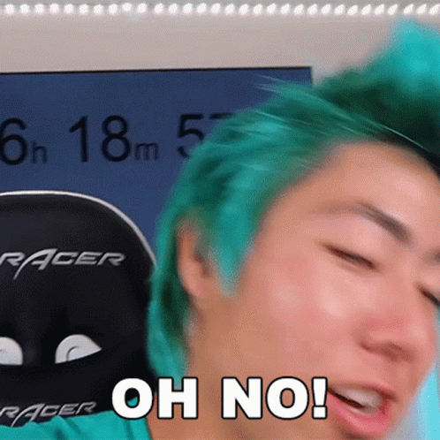 A Man With Green Hair Is Sitting In A Racer Chair GIF