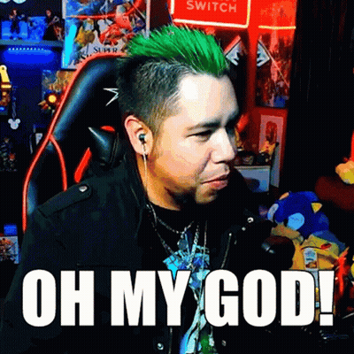 A Man With Green Hair Is Sitting In Front Of A Sign That Says Switch GIF