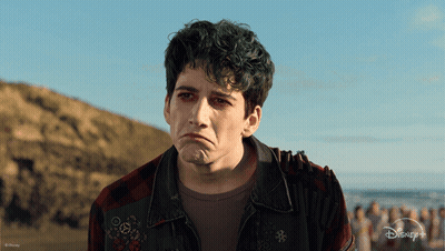 A Man With Green Hair Is Wearing A Plaid Shirt And A Disney + Jacket GIF