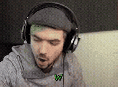 A Man With Green Hair Is Wearing Headphones While Sitting On A Couch . GIF