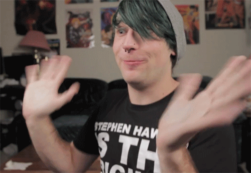 A Man With Green Hair Wearing A Stephen Haw Shirt GIF