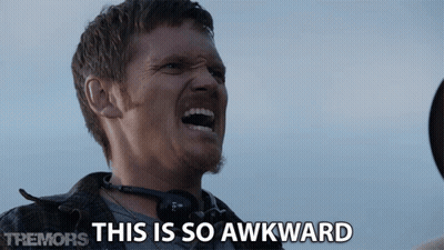 A Man With Headphones Around His Neck Is Screaming With The Words This Is So Awkward Behind Him GIF