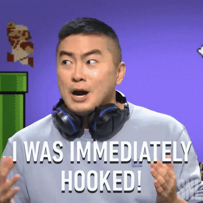 A Man With Headphones Around His Neck Says " I Was Immediately Hooked " GIF