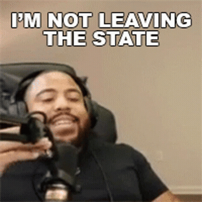 A Man With Headphones Is Holding A Microphone And Saying I 'M Not Leaving The State GIF