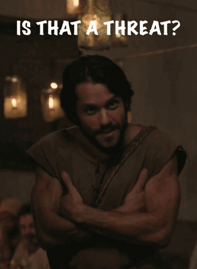 A Man With His Arms Crossed Has The Words Is That A Threat Written Above Him GIF