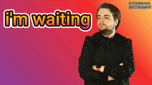 A Man With His Arms Crossed Is Standing In Front Of A Sign That Says I 'M Waiting GIF