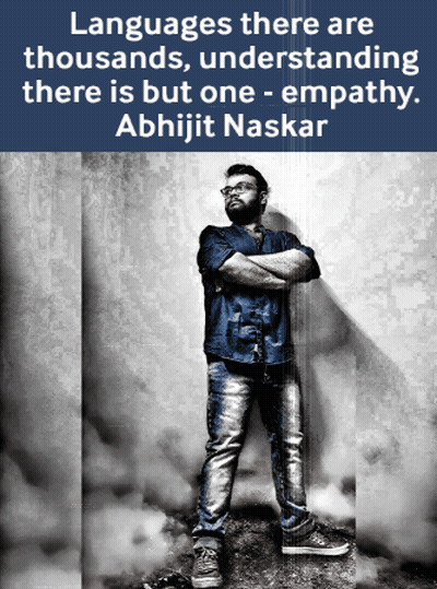 A Man With His Arms Crossed Is Standing In Front Of A Wall With A Quote From Abhijit Naskar GIF