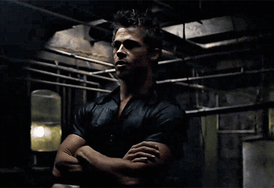 A Man With His Arms Crossed Looks At The Camera GIF