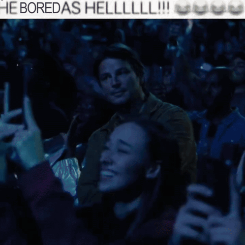 A Man With His Arms Crossed Stands In Front Of A Crowd With The Words He Boredas Helllll !!! Above Him GIF