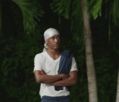 A Man With His Arms Crossed Wearing A Bandana GIF