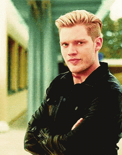 A Man With His Arms Crossed Wearing A Black Jacket GIF