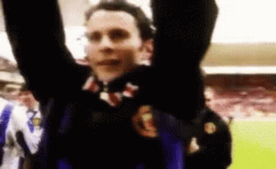 A Man With His Arms In The Air Is Wearing A Jersey With The Letter G On It GIF