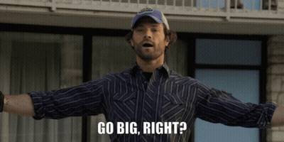 A Man With His Arms Outstretched And The Words Go Big Right Below Him GIF