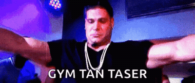 A Man With His Arms Outstretched And The Words Gym Tan Taser On The Bottom Right GIF