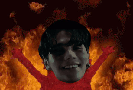 A Man With His Arms Outstretched In Front Of A Fire GIF