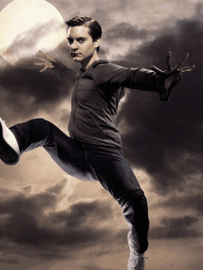 A Man With His Arms Outstretched Is Kicking A Ball In Front Of A Full Moon GIF