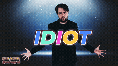 A Man With His Arms Outstretched Is Standing In Front Of The Word Idiot GIF