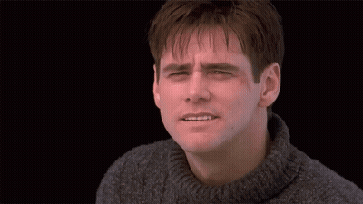 A Man With His Arms Outstretched Standing In Front Of A Door GIF