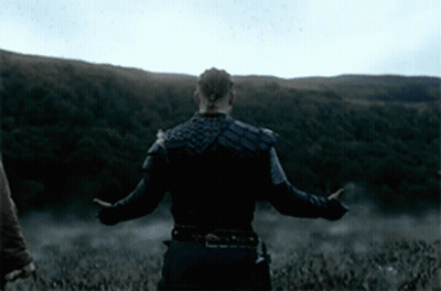 A Man With His Arms Outstretched Stands In A Field GIF