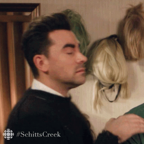 A Man With His Eyes Closed And The Word Schitts Creek On The Bottom Left GIF