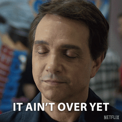 A Man With His Eyes Closed And The Words It Ain 'T Over Yet Above Him GIF